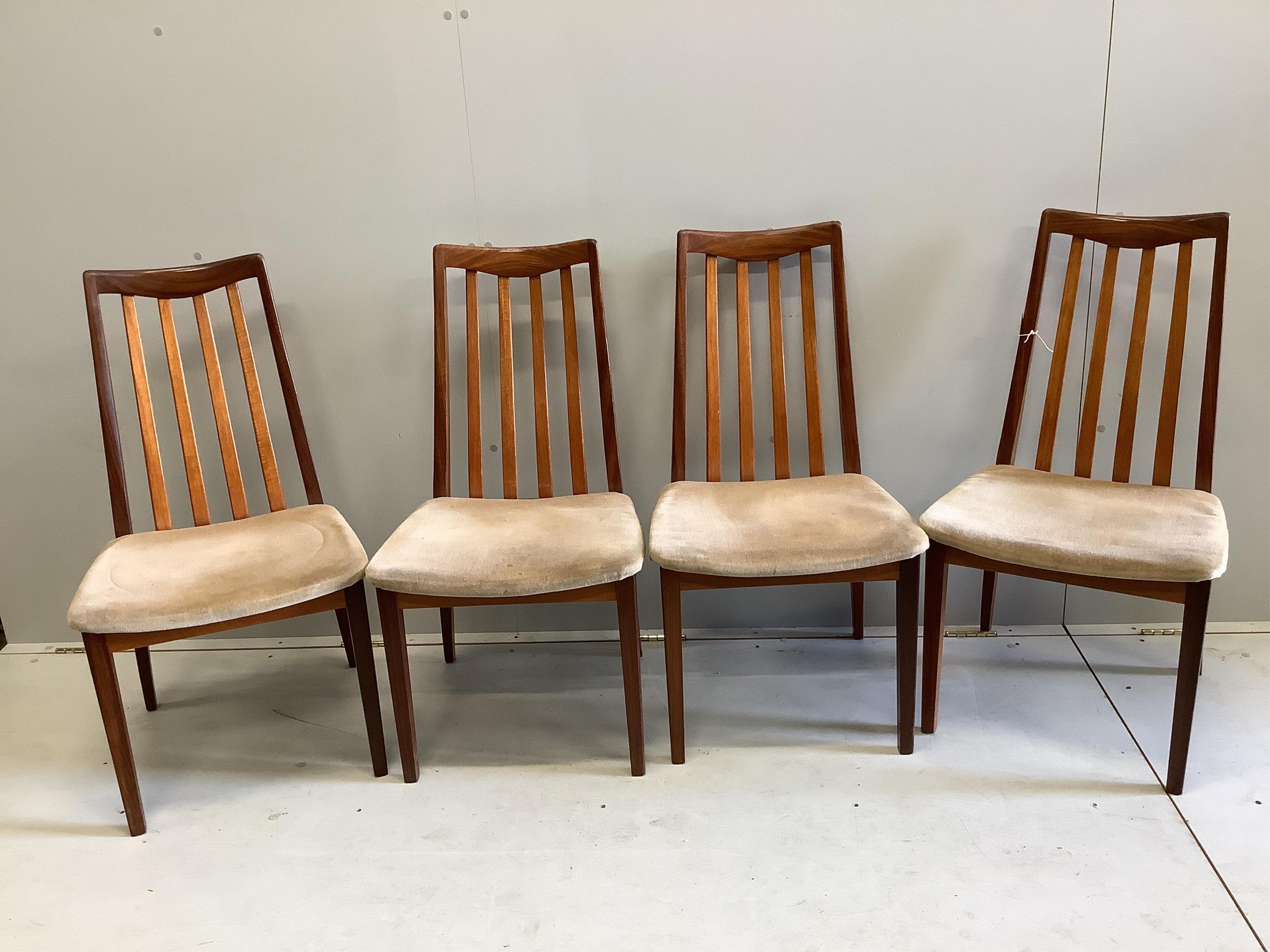 A mid century G Plan teak circular extending dining table, diameter 122cm, four chairs and sideboard, width 138cm, depth 44cm, height 72cm and a nest of tables. Condition - fair